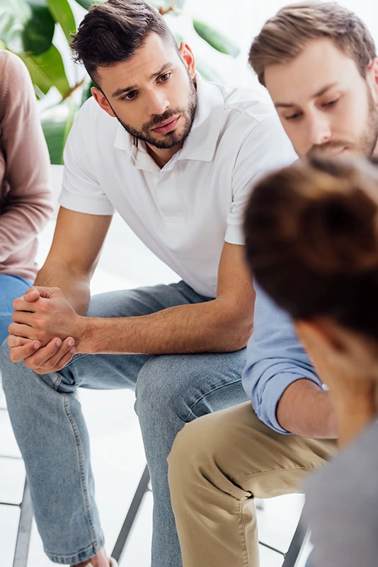 People participate in therapy at a drug rehab center.