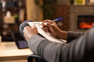 Therapist writing notes on a dual diagnosis assessment.