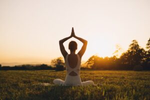 Young woman practicing yoga for addiction recovery.