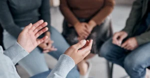 People in a meeting are talking about addiction stigma.